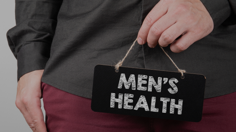 Photo of a person holding a sign saying "Men's Health"